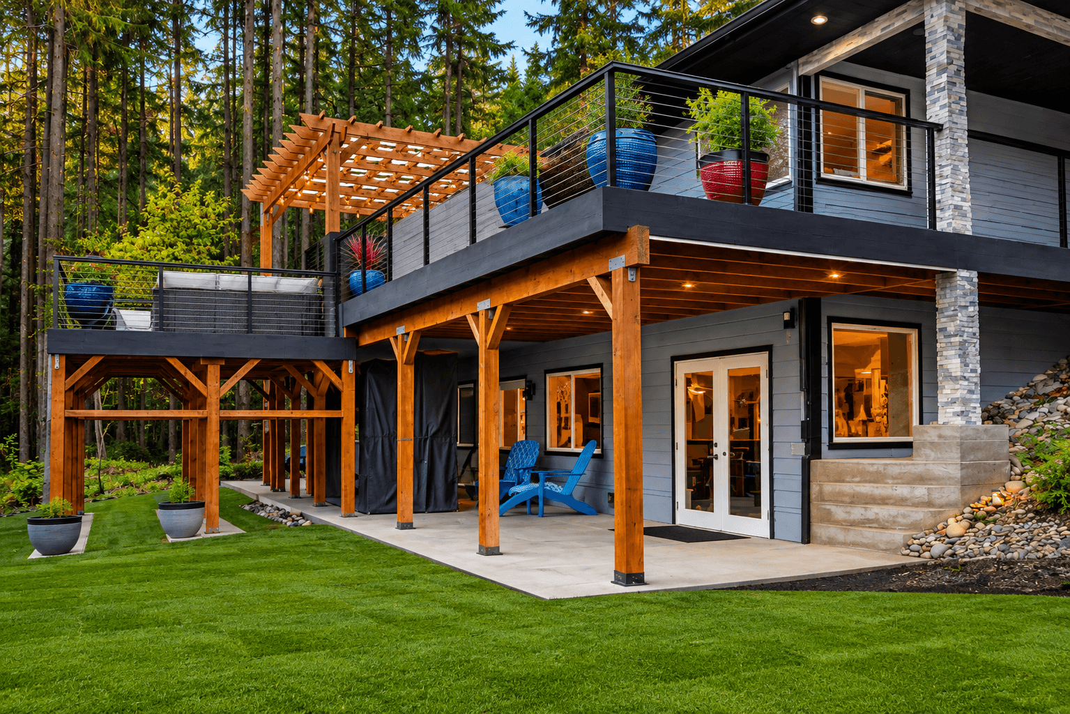 Covered deck with outdoor kitchen and lake view at golden hour